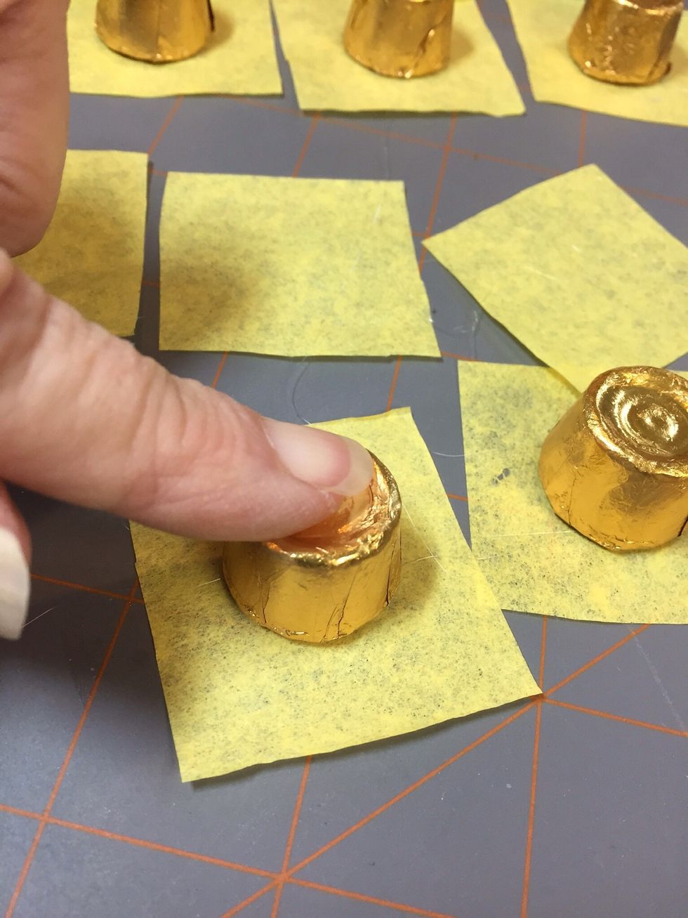 Press candy down into hot glue.