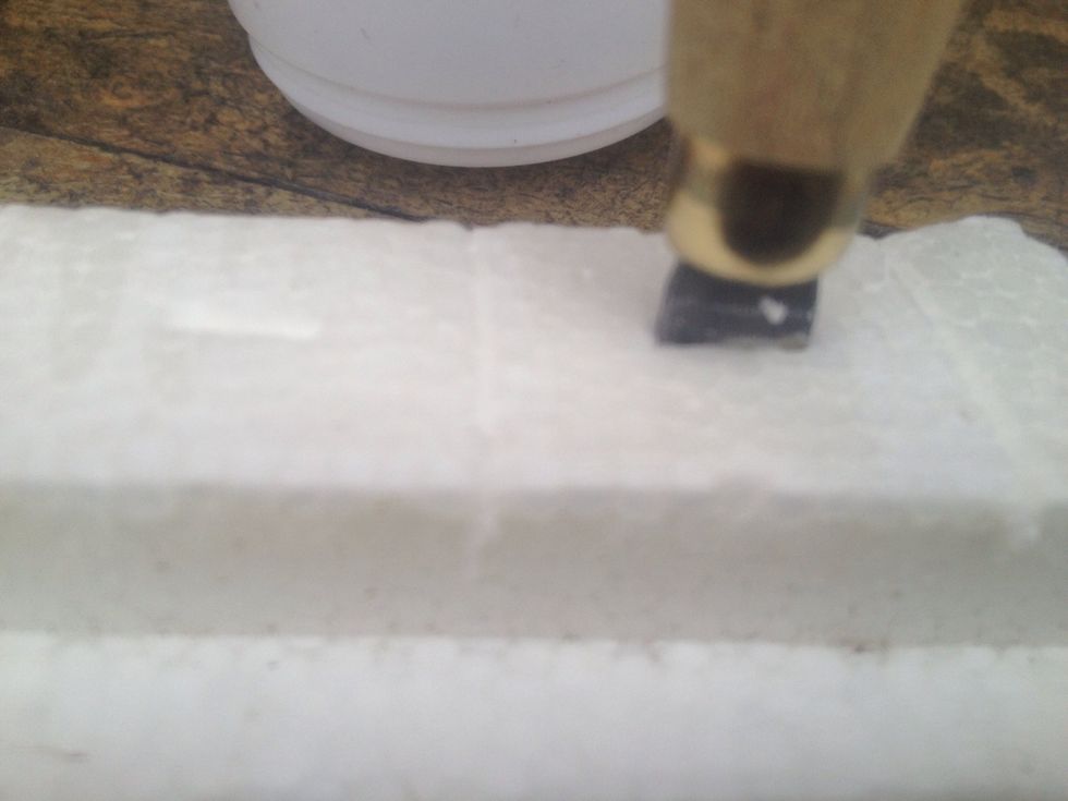 Press craft knife into polystyrene till you hit your bench then score a line to separate sprouted seeds