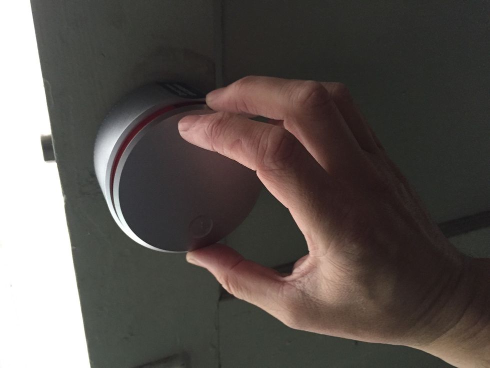 Press down on the face place and rotate it counterclockwise to open the battery compartment. Don\u2019t remove the factory seal on top until instructed to do so during the calibration process.