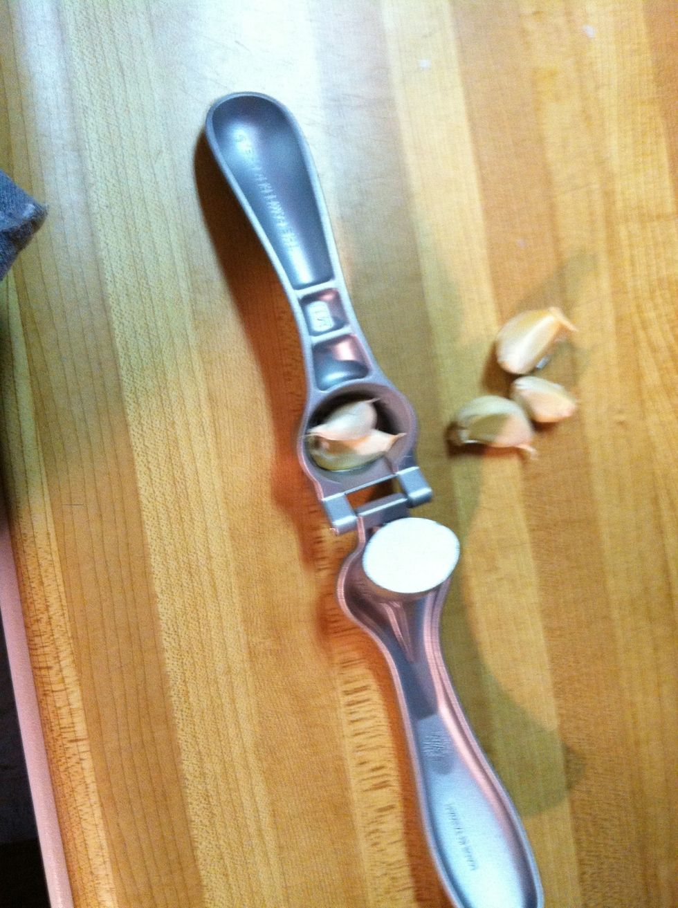 Press garlic directly into pan. You can peel and mince if you don't have a press.