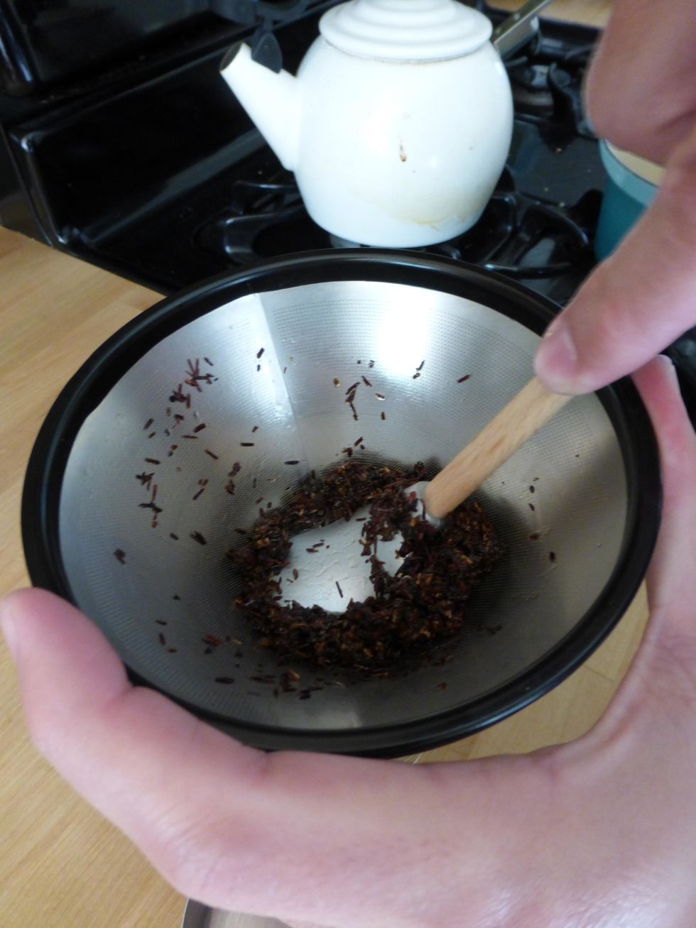 Press hard on the tea leaves using a small spatula to remove butter from leaves. Set melted tea butter aside.