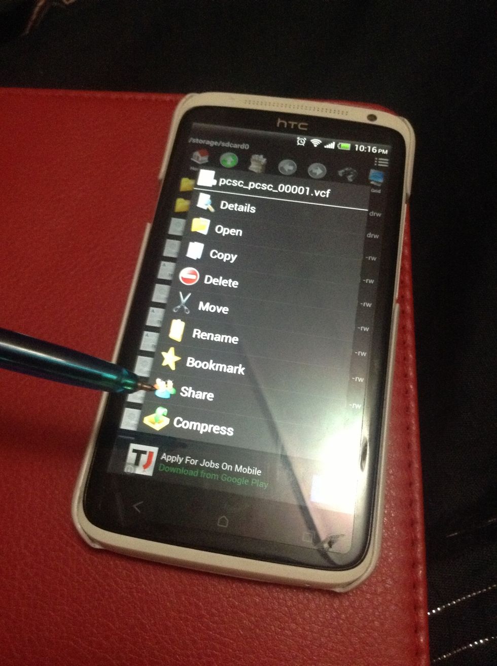 Press n hold the .vcf file n tap on share..