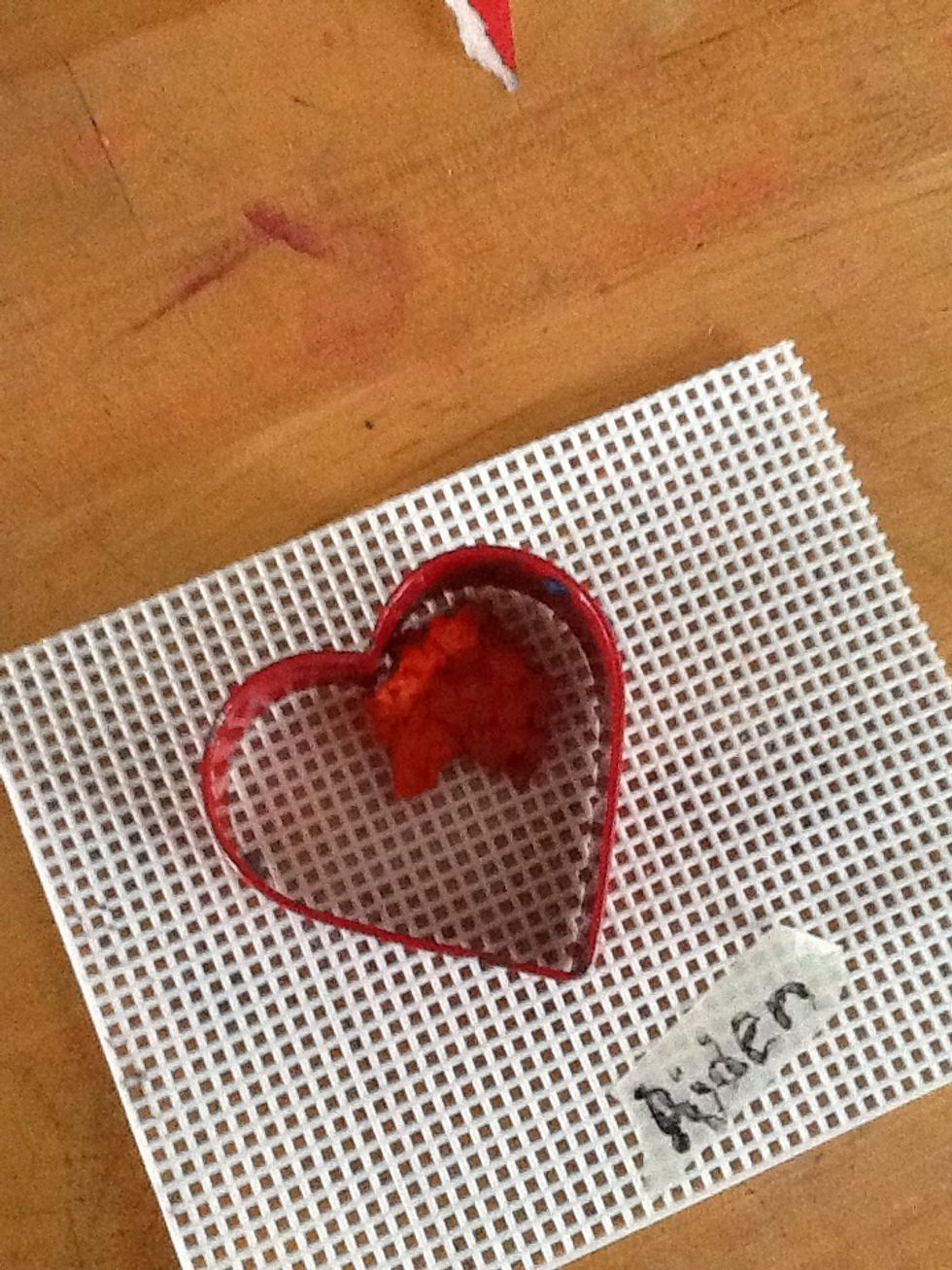 Press pulp into the cookie cutter, holding it in place as you go. Press down on the pulp, spreading it as thin as possible. Water will squeeze out. A layer of newspaper, underneath), will absorb it.