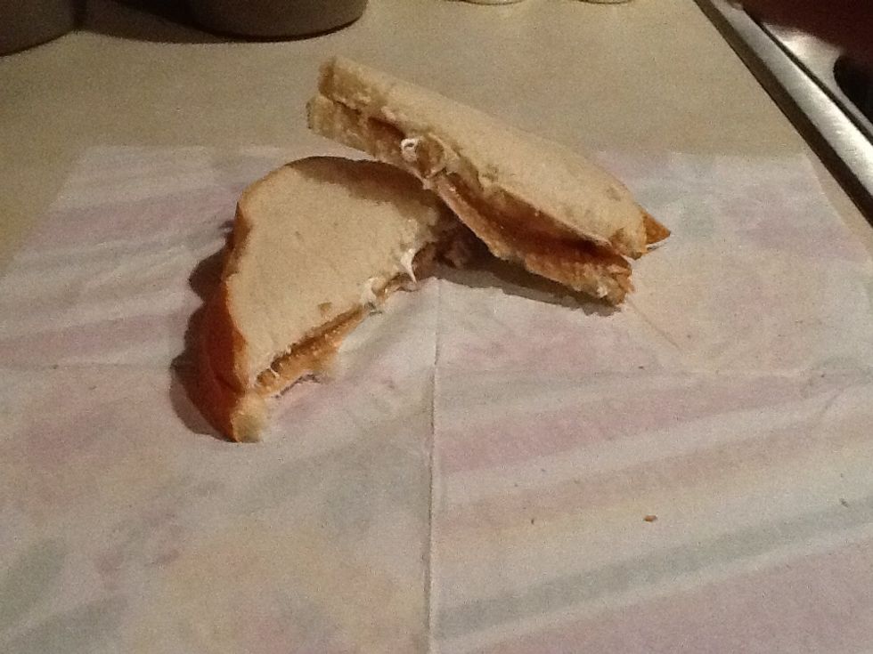 Press the 2 slices together lightly, and cut bread in half. Then, enjoy your peanut butter and marshmallow sandwich!