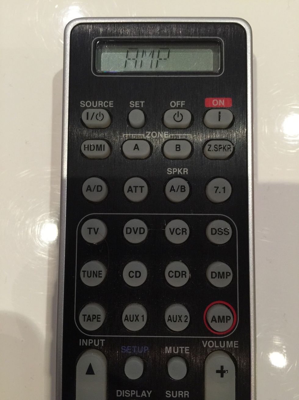 Press the AMP button on the remote. Point it at the Marantz AMP and once again press the Source / Power Button (top left). You should hear a click and the display should come on.