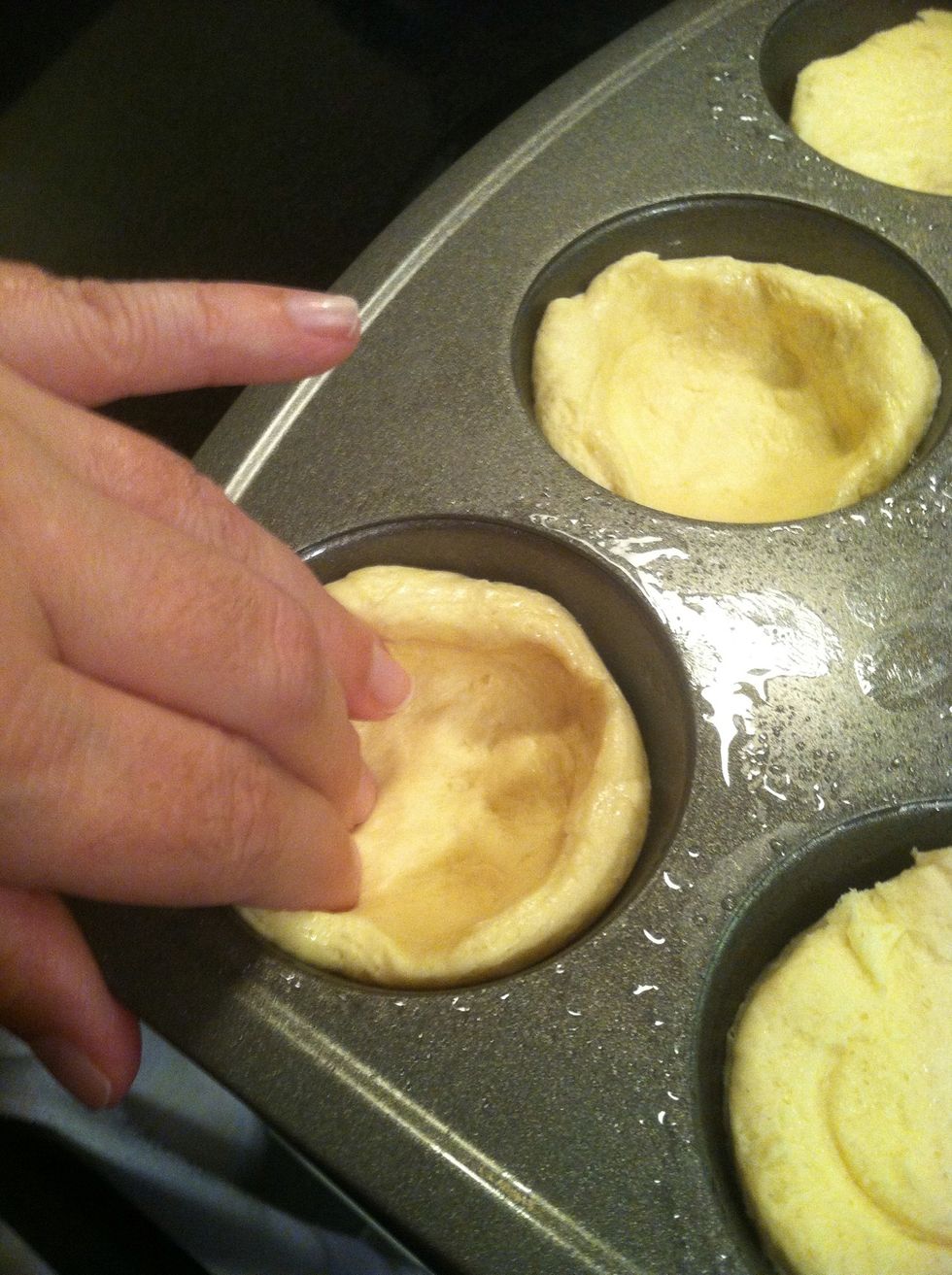Press the biscuit dough into a cup shape.  *get them to go up the sides a little more than I did, as mine didn't "envelope" the broccoli and cheese as much as I'd liked.