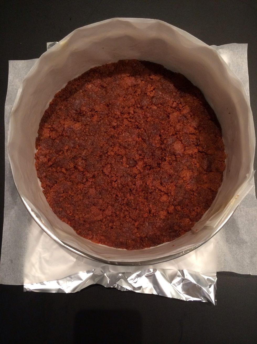 Press the biscuits in the mould. Put the fridge. Or you could put it 5 mins to bake. The 1 TBsp of sugar helps to cement the crust. Then let to cool