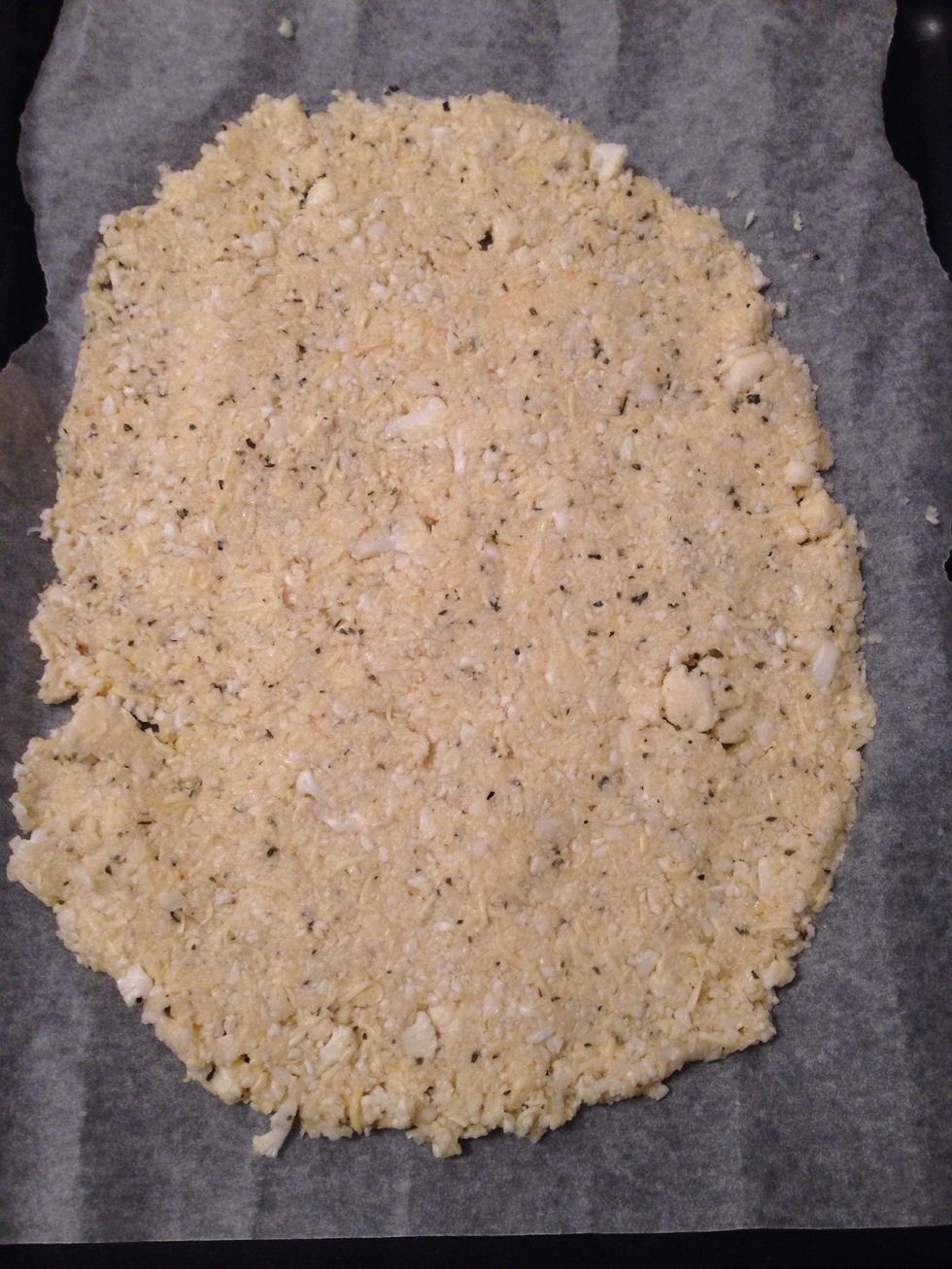 Press the califlower mix evenly on parchment paper.