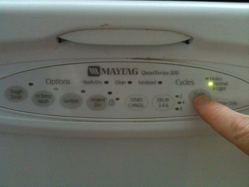 Press the cycle select button until the normal light turns on.