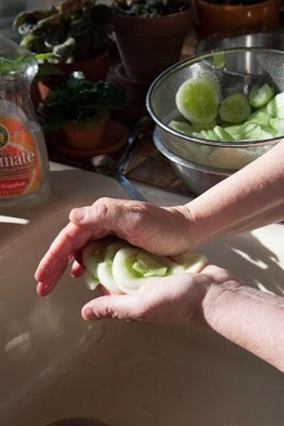 Press the excess water out of the cucumbers.