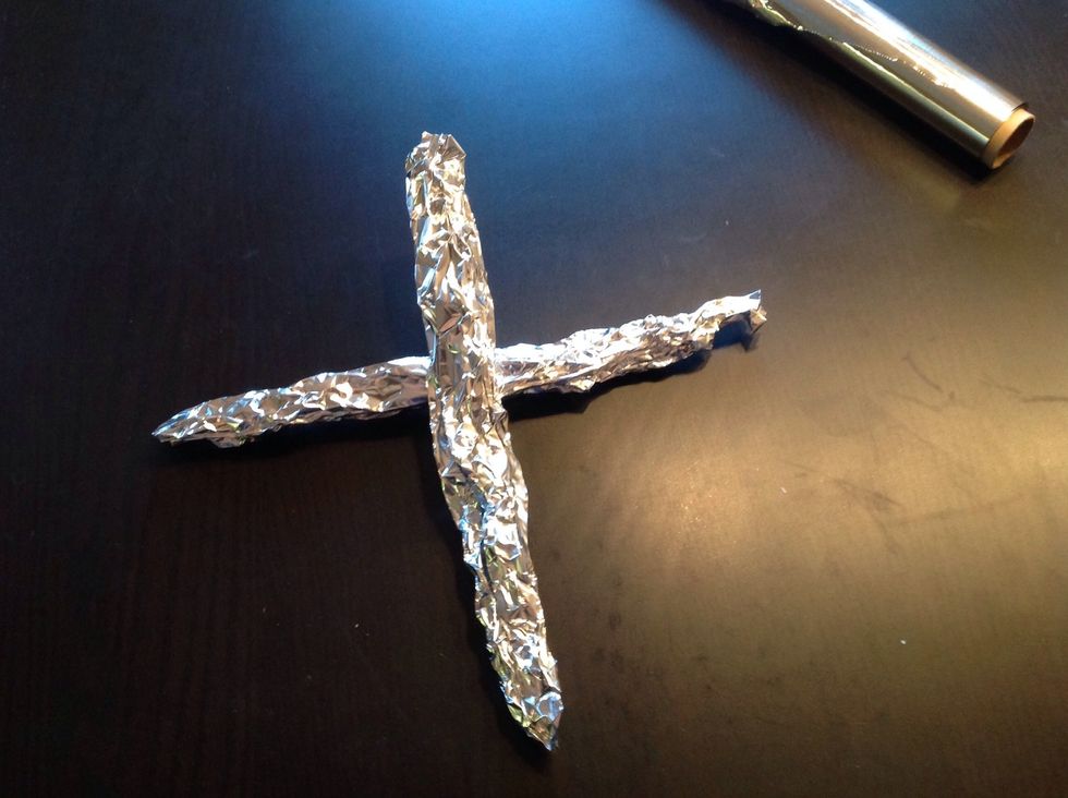 Press the foil into the shape of two sticks.