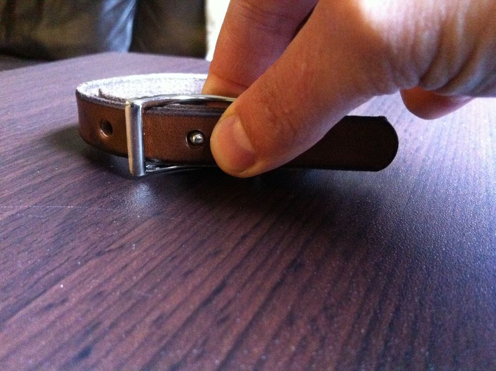 Press the hole onto the prong, on top of the first strap