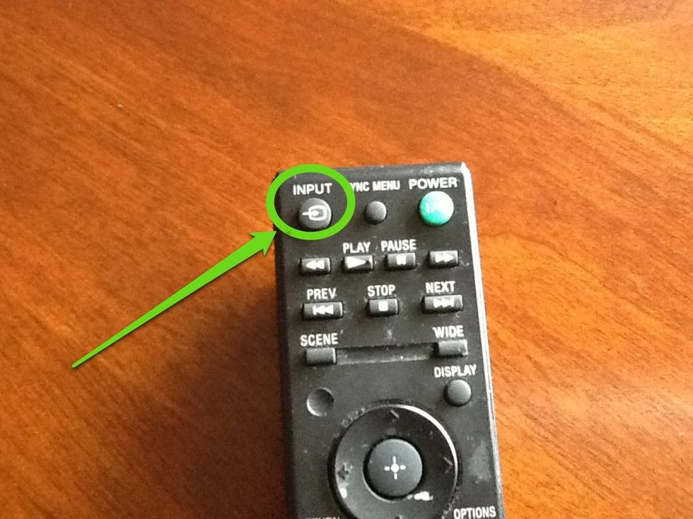 Press the Input button on the remote.