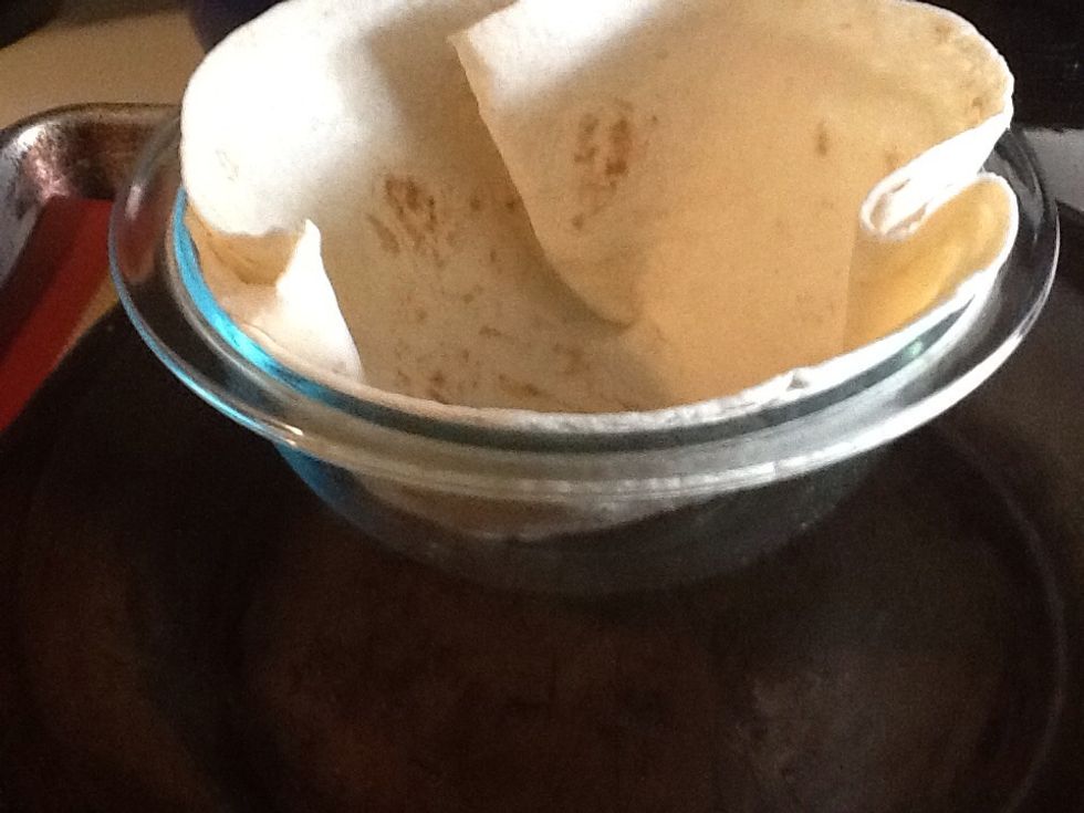 Press the large tortillas into the bowl to make sure the bottom is pressed completely to the bottom of the bowl.  This will create the base for the tortilla.