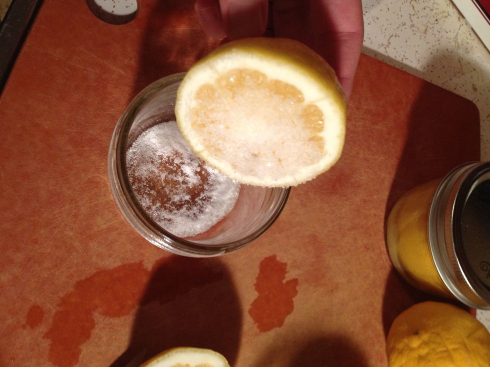 Press the lemon into the salt, then place in jar