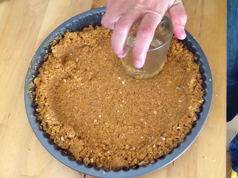 Press the mixture to the edges of the tin with a glass or a flat bottomed object evenly