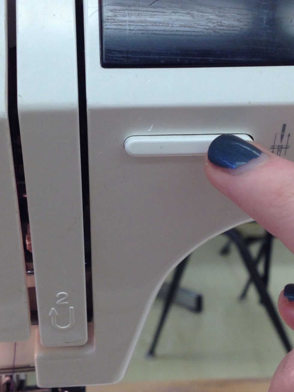 Press the needle position button twice.