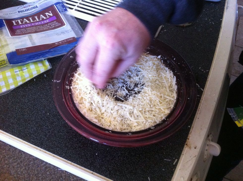Press the olives down so that they are even with the pressed down cheese mixture.  Sprinkle a little more Parmesan cheese on top .