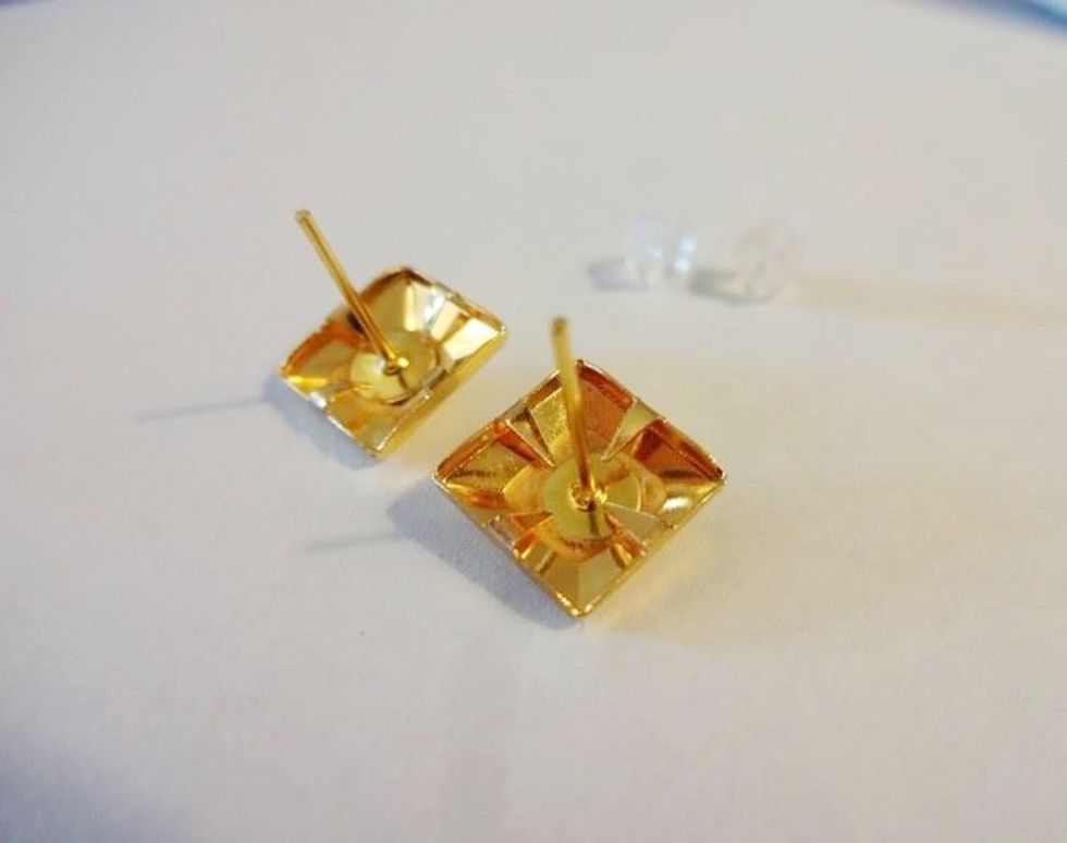 Press the prongs on the stud in towards the earring post in the centre. This prevents you from getting 4 extra piercings when you try and wear these earrings. It also helps to stabilize the post.