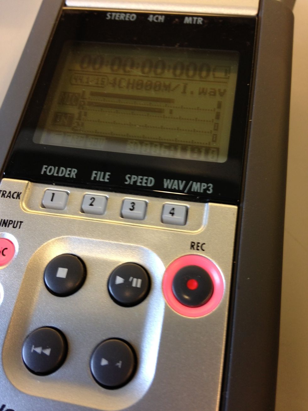 Press the Record button. It should start blinking but recording has not started yet. To record, press Record again. The light should be solid red and the timecode will start. Press Record to stop.
