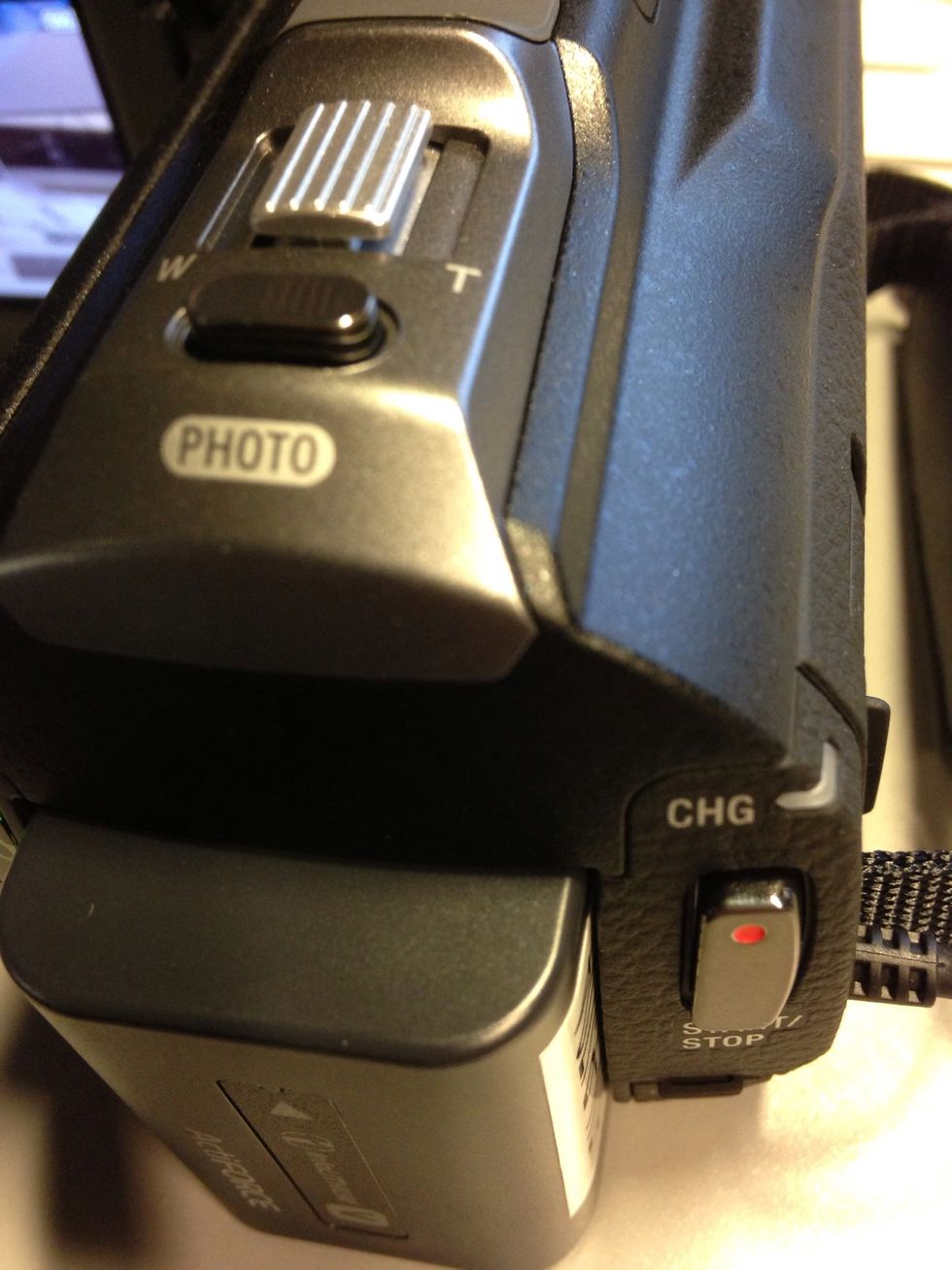 Press the Record button (with a red dot) to begin recording video. Press it again to stop. Use the gray dial at the top to zoom in or out.