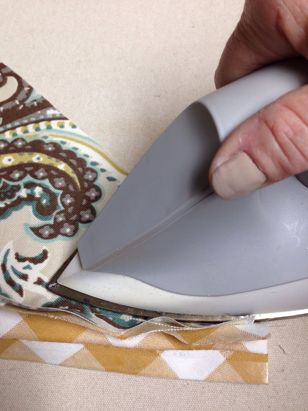Press the seam and the raw edges toward the bias banding being careful not to touch the iron to the side with Steam-A-Seam-II previously applied.