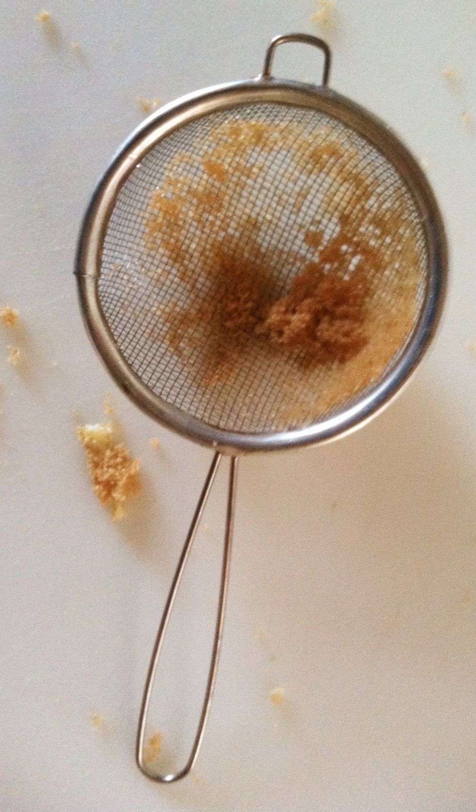 Press the sugar through a strainer onto the top of the cake.