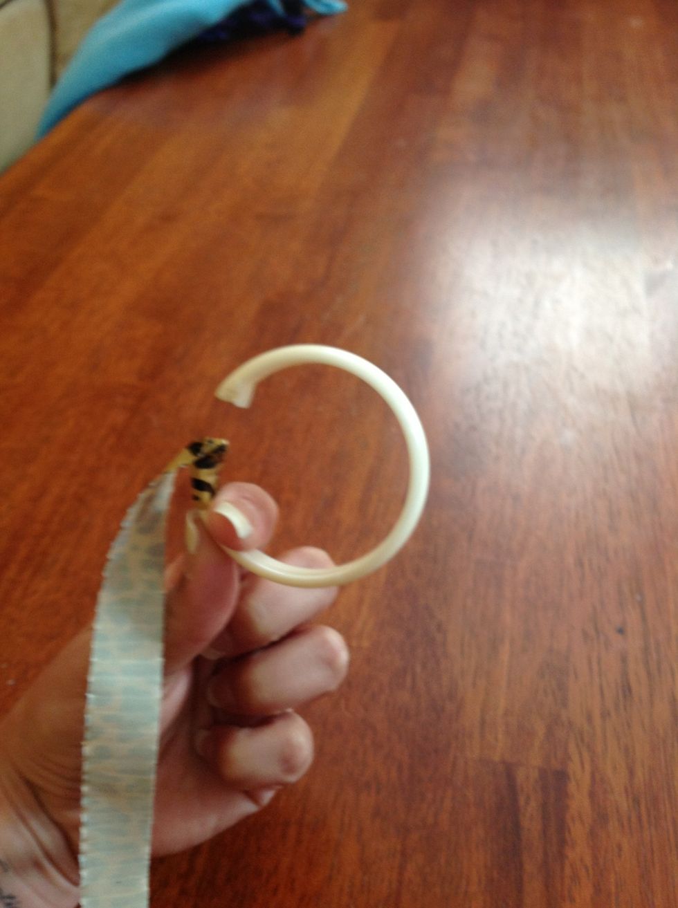 Press the tape down around the sides of the ring, then press down any corners from where the top meets the folded sides.