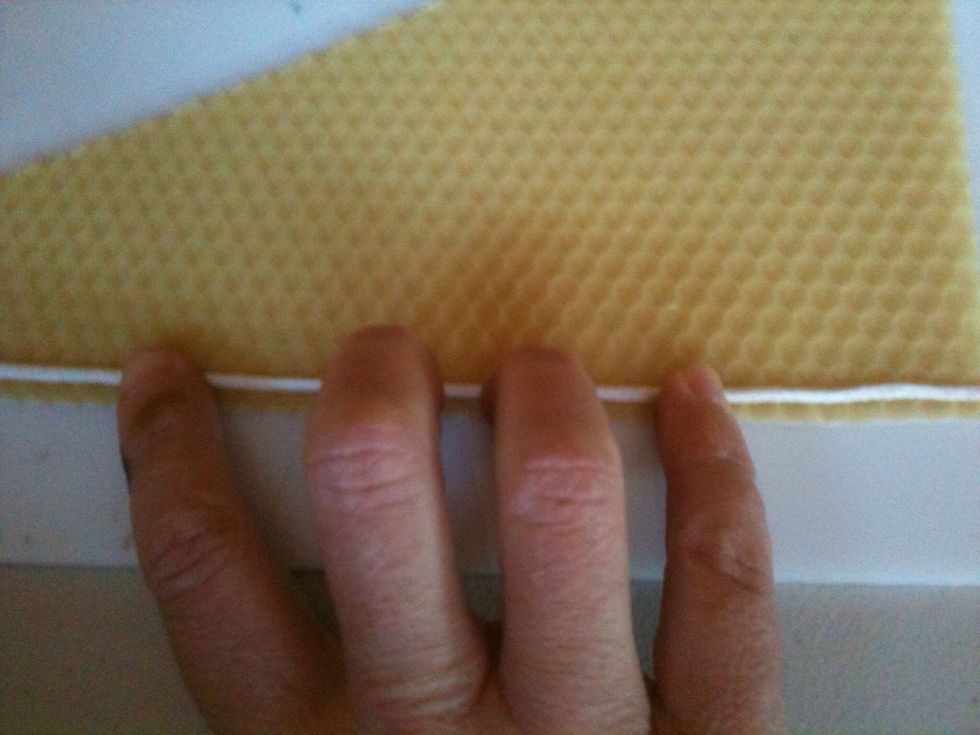 Press the wick gently into the wax, causing it to stick and stay in place.