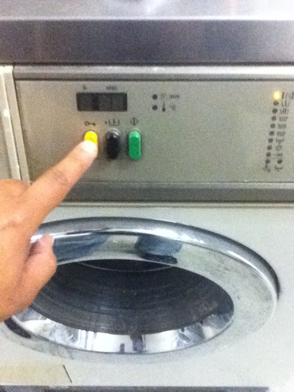 Press the yellow button to open the door and remove your clean laundry
