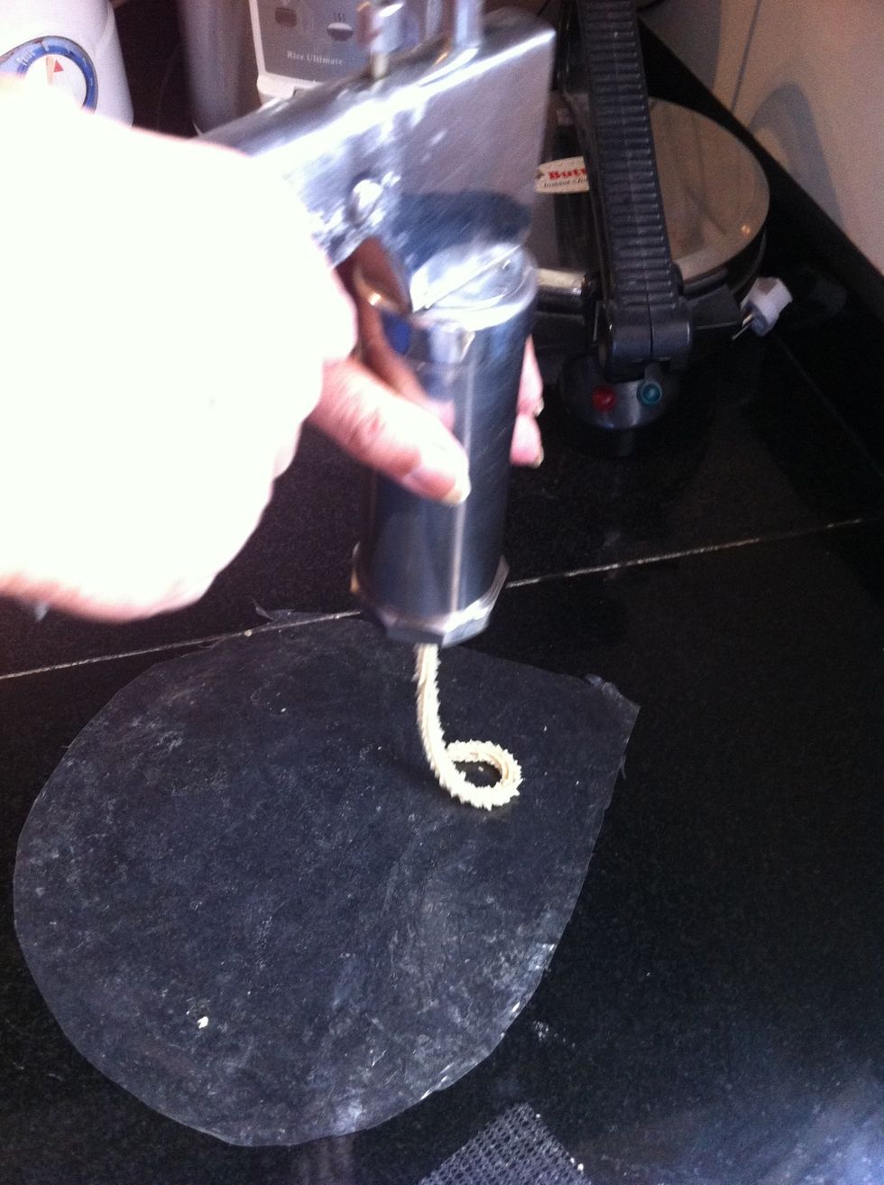 Press to make round shape on the oil applied plastic sheet so that it will be easy to lift later