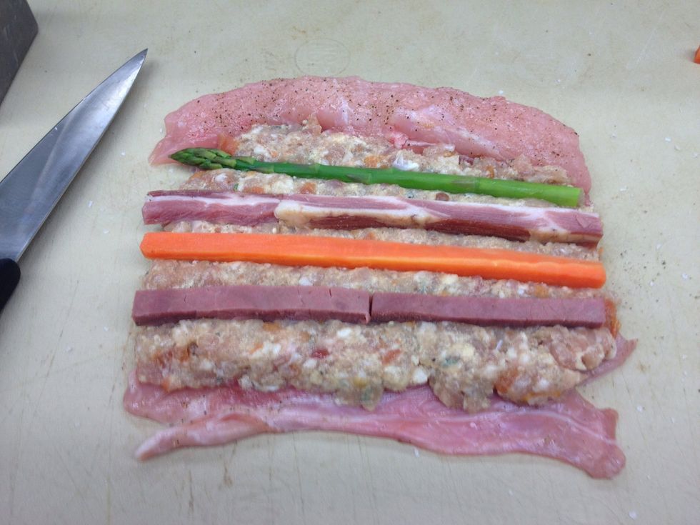 Press vegetables and meat batons into the forcemeat, laying them out parallel to each other.