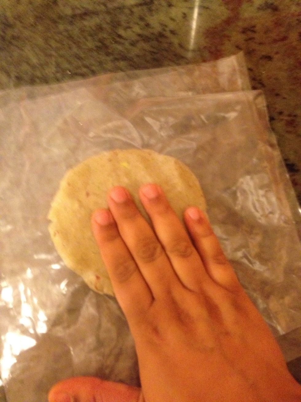 Press with your hand so that you can flatten it .