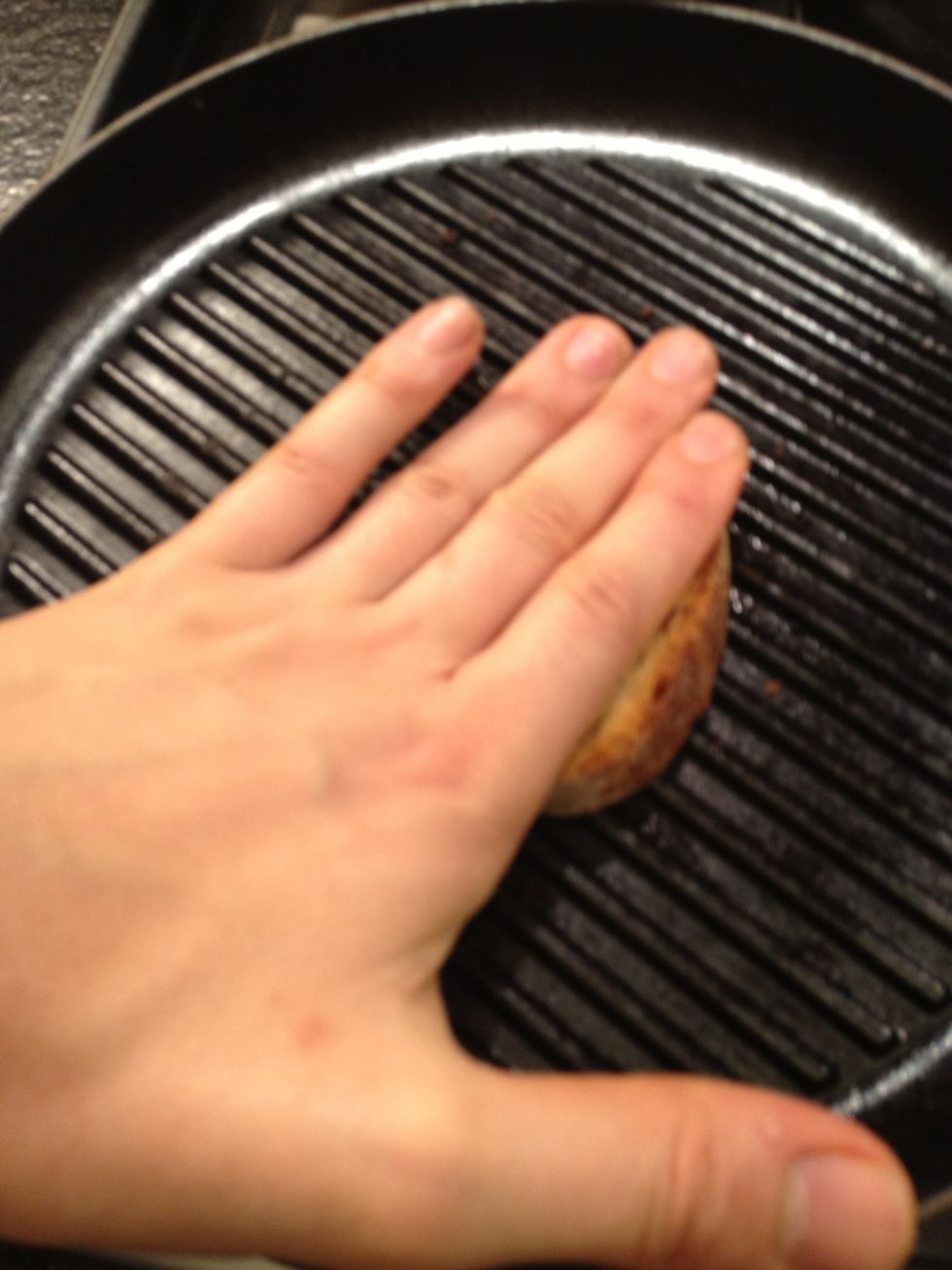 Press without burning yourself. You don't need to use your hand.