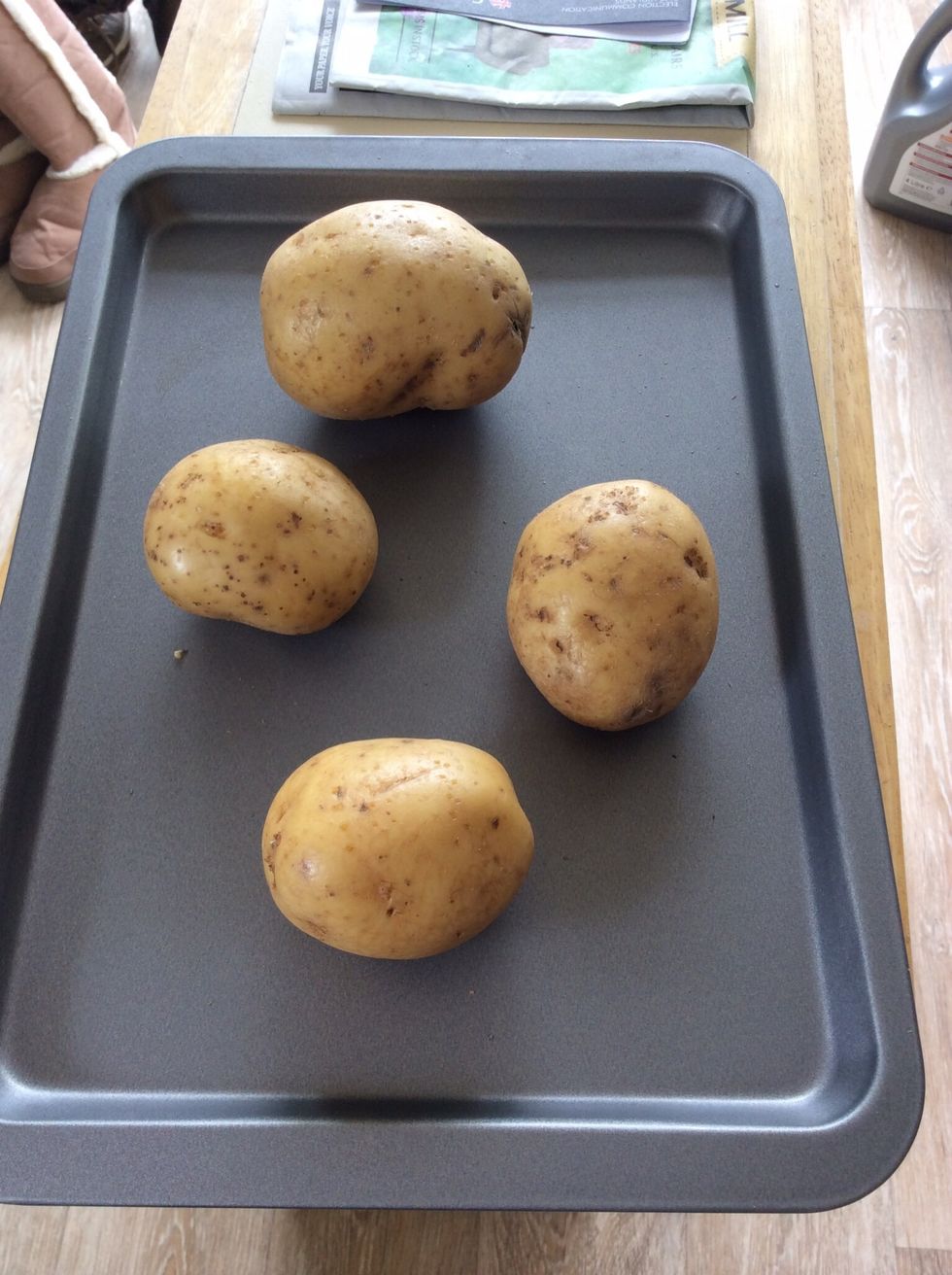 Prick your potatoes all over and arrange on a baking sheet