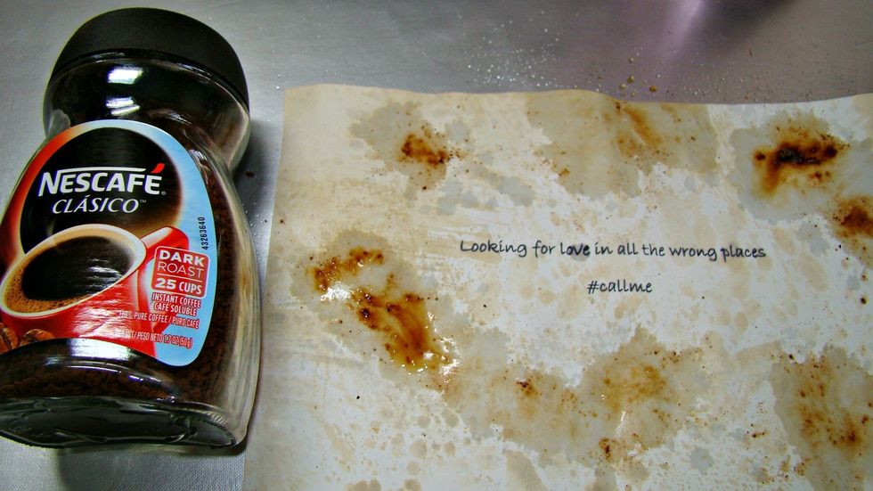 Print out your message and sprinkle instant coffee here and there and spritz with water. Heat set.