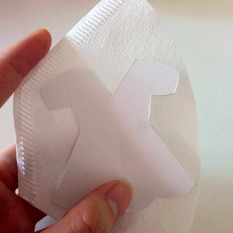 Print the templates out from my blog, or YouTube channel (or at this link http://goo.gl/mRfttV) and trace them over a sturdy cardboard... Hold the template onto the coffee filter firmly as shown...