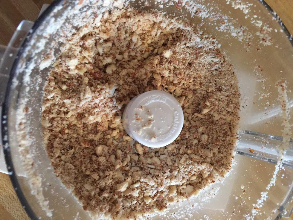 Process nuts until finely ground