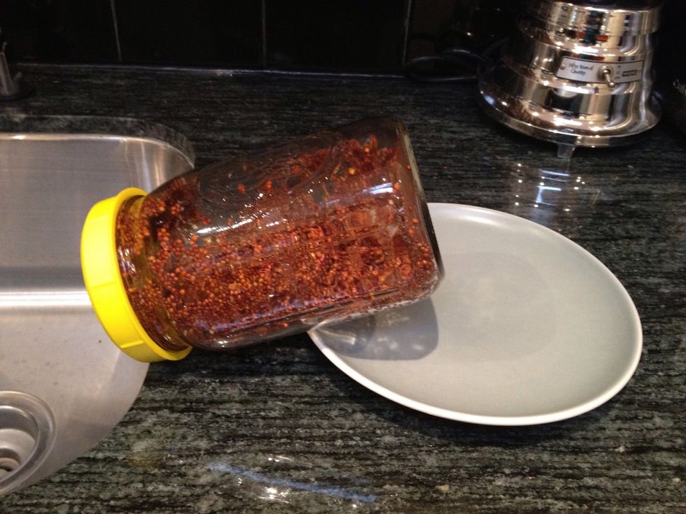 Prop the jar at an angle with the screen facing down, so any excess water can drain off. Make sure the seeds are distributed around the jar, and not blocking the screen. Keep in a cool, dark place.