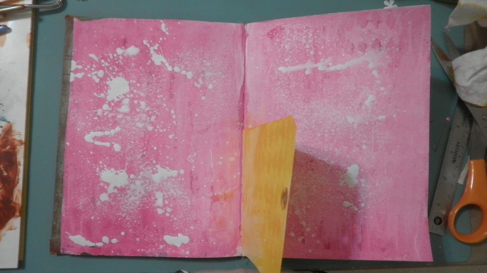 Protect tag and spray both pages with the DecoArt White Mister and let dry. Some puddles are very thick, giving great texture for the steps to come.