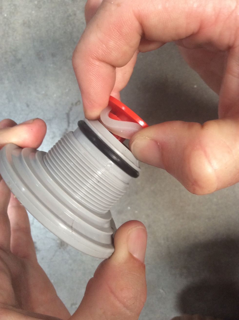 Pry clear with your fingers, not a screwdriver or sharp object.  The washer just needs to pop into the groove closest to the end.