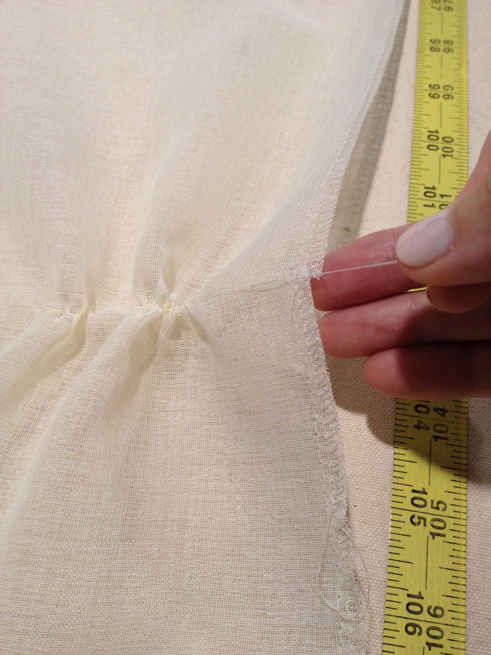 Pull a thread of fabric along the entire width of the panel. This will give you a very straight line across the grain of the fabric. Cut along this line with your scissors.