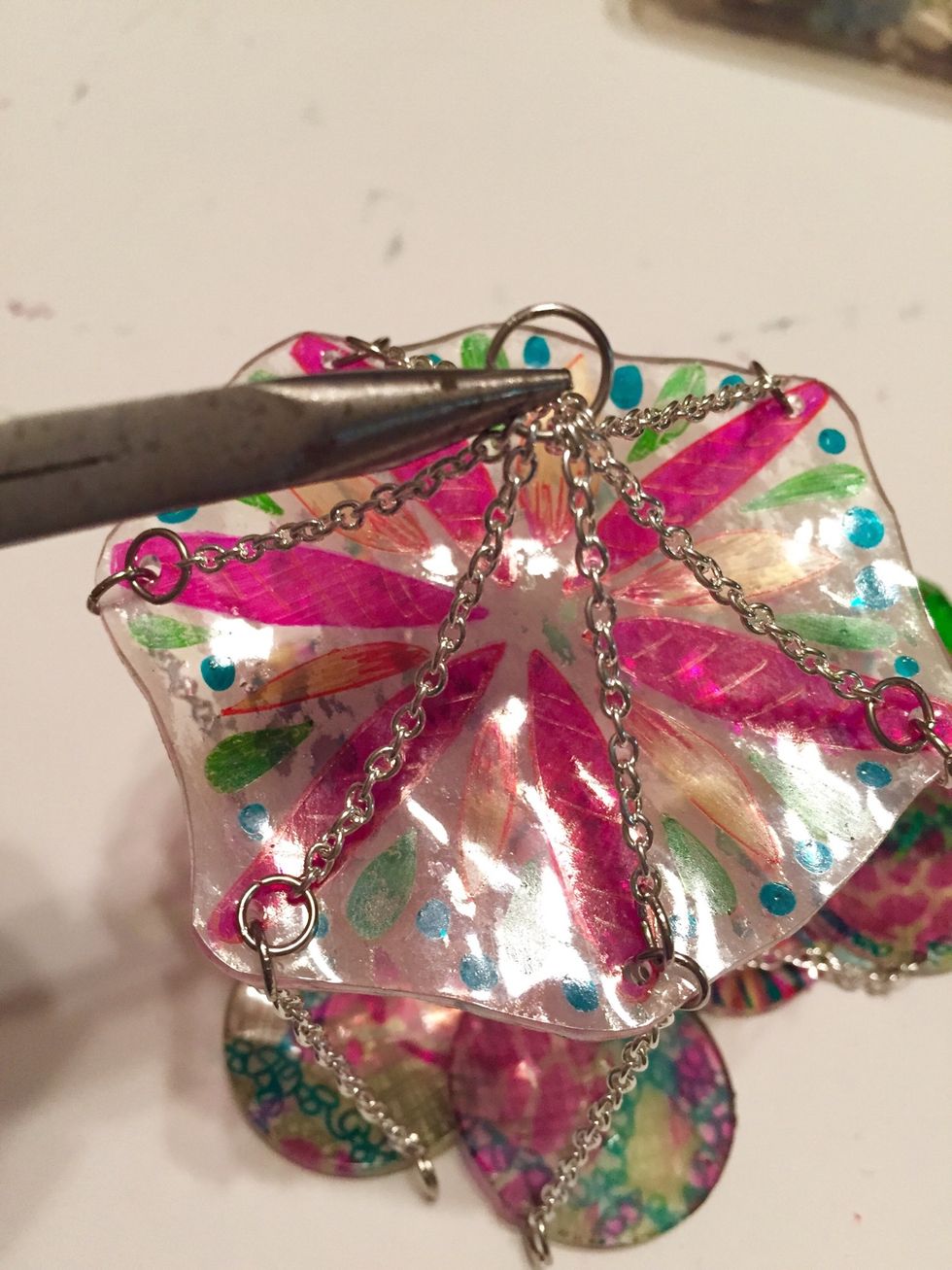pull all chains to center and link using large jump rings. shorten any chains as needed to balance top.