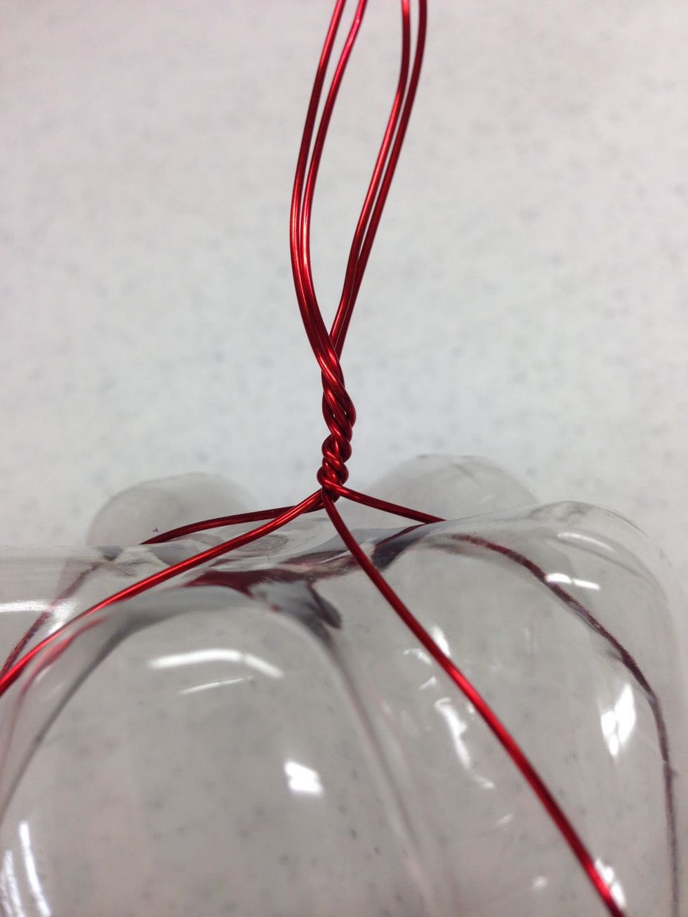 Pull all of the wire ends into a "ponytail" over the base of the bottle. Twist the whole bundle a few times to keep in place.