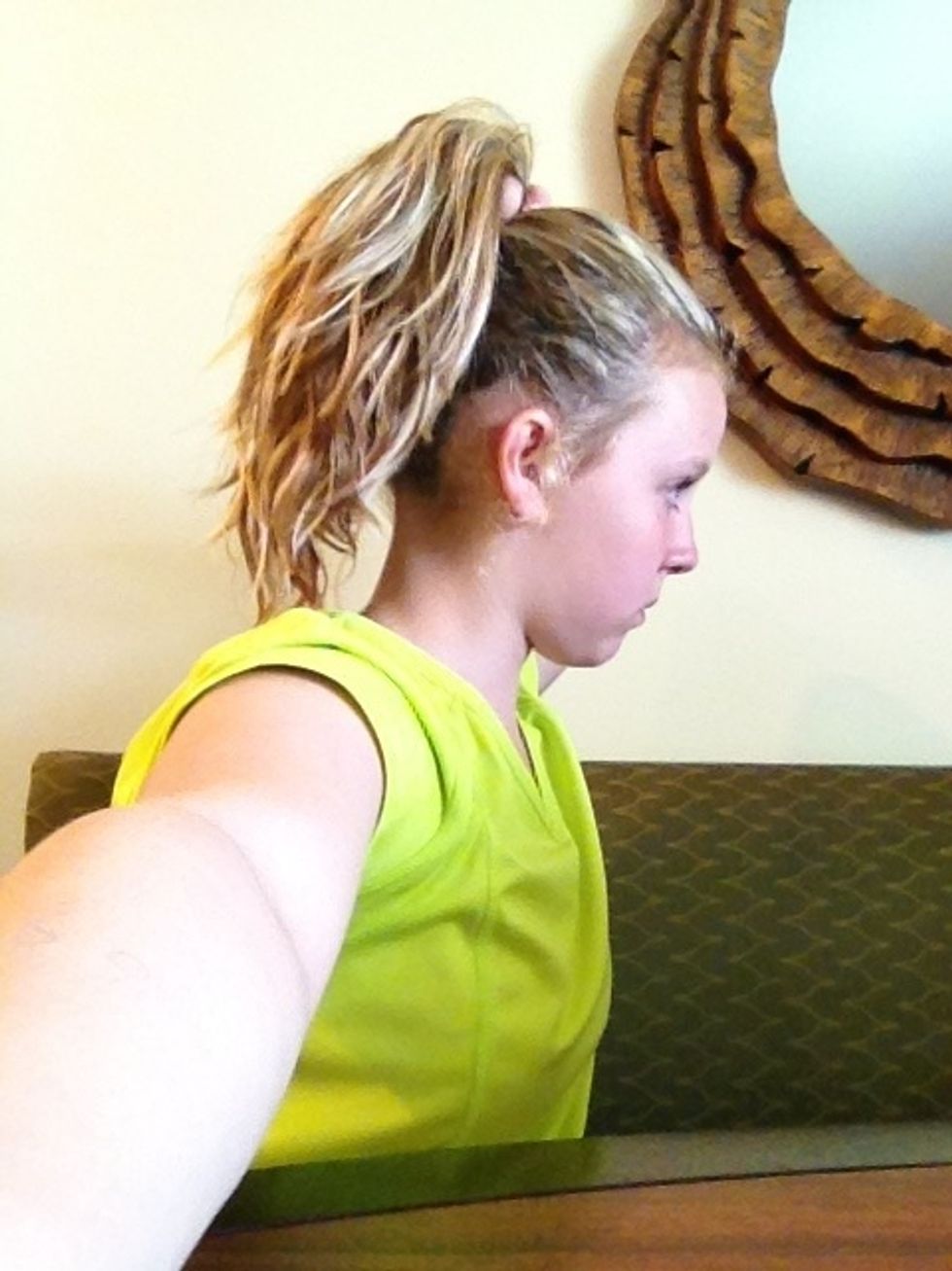 Pull all your hair back where you want your bun to be