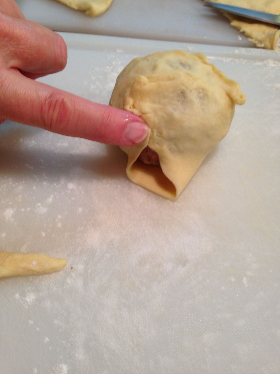 Pull and overlap and pinch dough as needed to totally encase each meat/egg ball.
