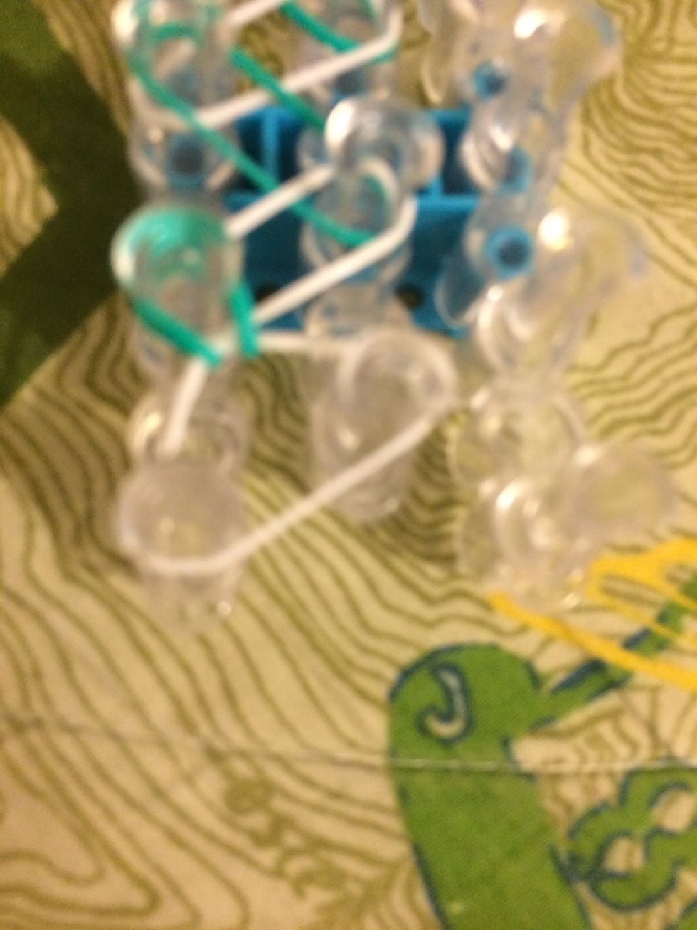 Pull back the 2nd band. Loop it up and over to the adjacent pin