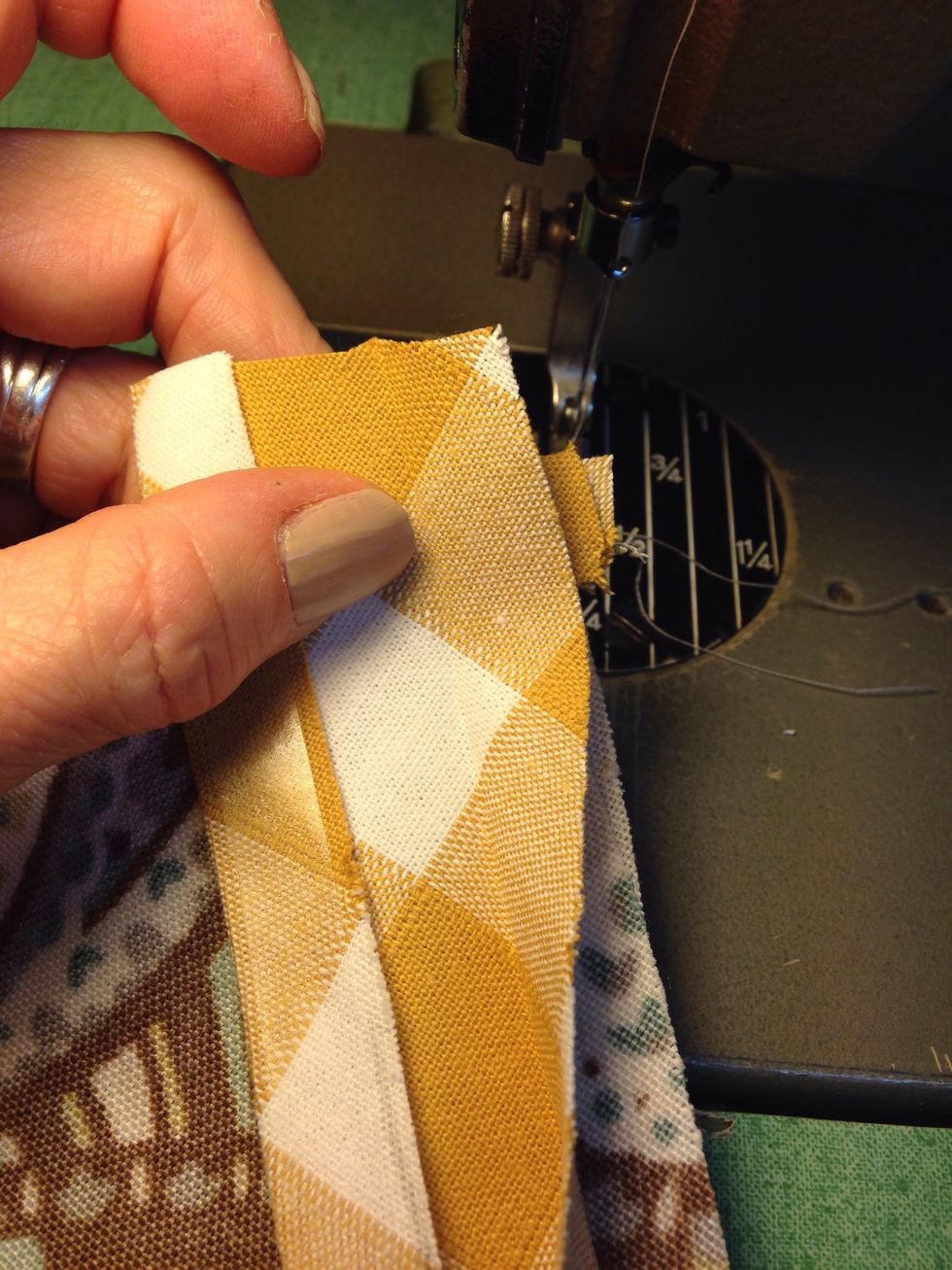 Pull bias banding past the end of the point. Wrap the end of the bias banding around the previously applied banding.