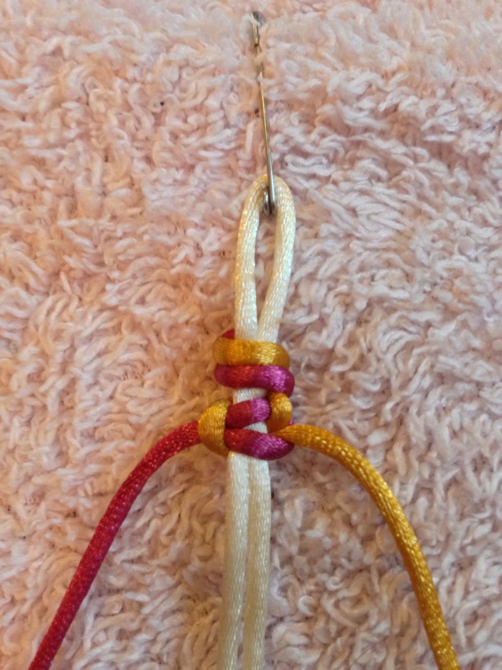 Pull both LEFT and RIGHT threads up the core until it reaches your last knot and pull tight.