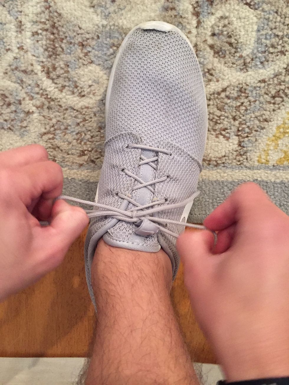 Pull both "loops" until they are tight on the arch of your foot